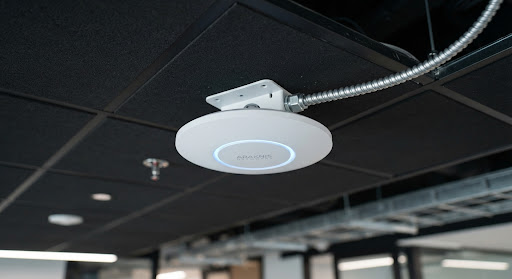 Wi-Fi access point mounted on an office ceiling